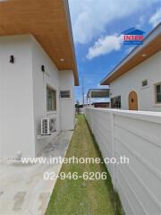 Side walkway view with adjacent houses