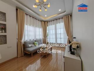 Well-lit living room with a sofa and large windows