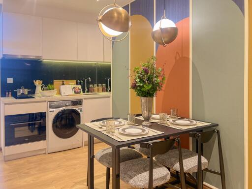 Modern kitchen with dining table and washer