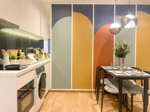 Modern kitchen and dining area with decorative wall panel.