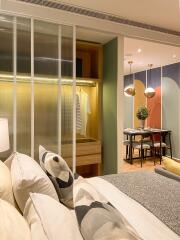 Modern bedroom with a view into the dining area