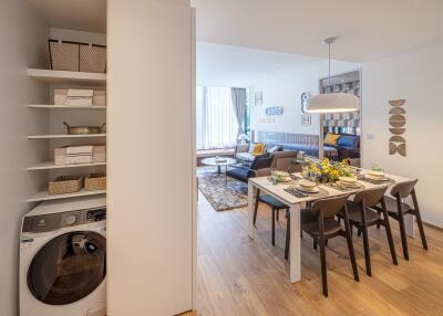 Modern living room and dining area with laundry space