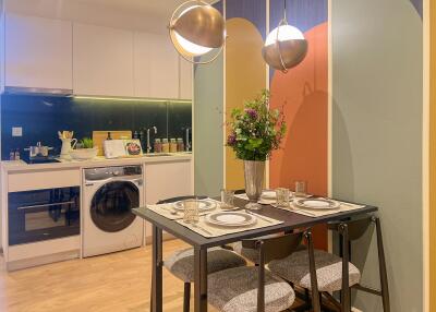 Modern kitchen and dining area with laundry setup