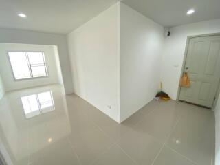 Spacious entryway with ceramic tiled floor and storage closet