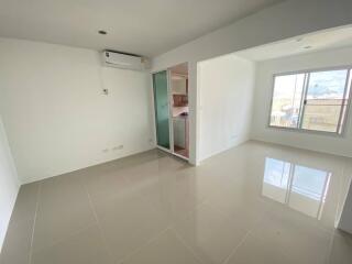 Spacious living room with large window and air conditioner