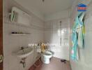 Bathroom with white tiles and a wall-mounted sink