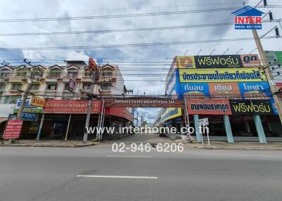 Street view of commercial buildings with multiple storefronts