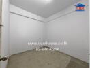 Empty room with white walls and concrete floor