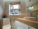 Modern bathroom with mosaic tiles and decorative window