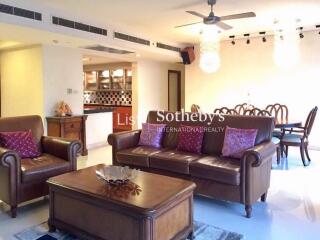 Spacious and well-lit living room with leather furniture