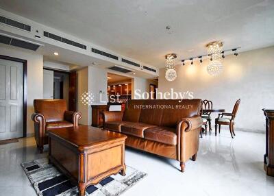 Living room with leather furniture and chandelier lighting