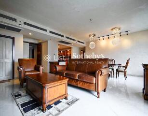 Living room with leather furniture and chandelier lighting