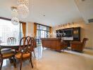 Spacious living room with chandeliers, dining area, and large windows