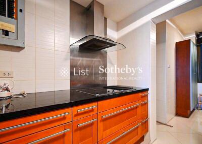 Modern kitchen with orange cabinets and black countertop