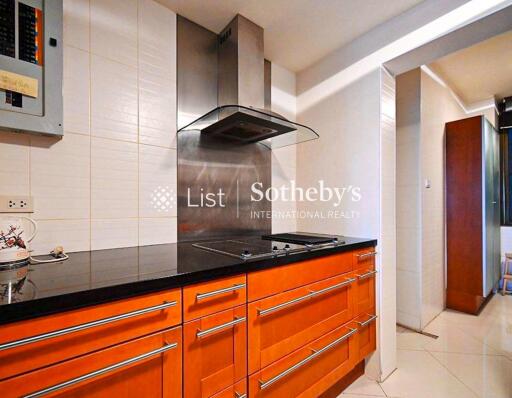 Modern kitchen with orange cabinets and black countertop