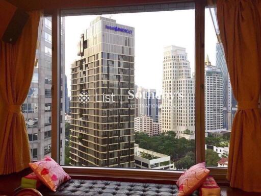 View from window showing cityscape with high-rise buildings