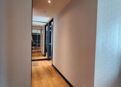 Long hallway with wooden floors and modern decor