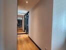 Long hallway with wooden floors and modern decor