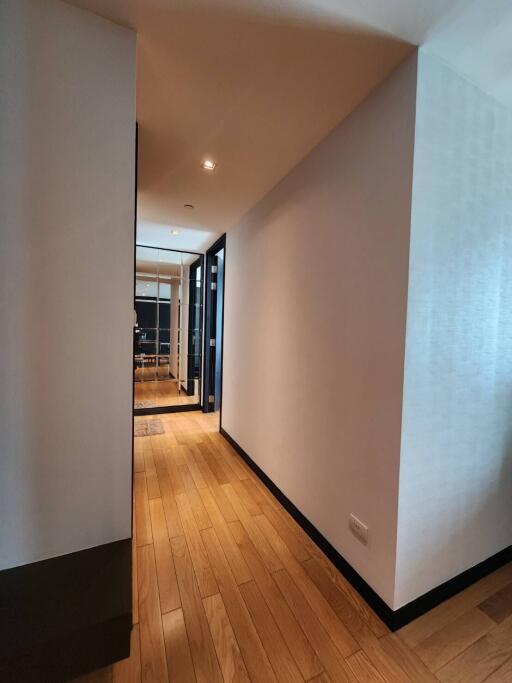 Long hallway with wooden floors and modern decor