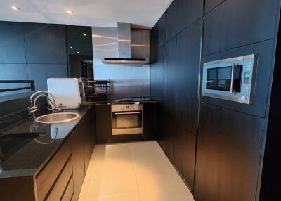 Modern kitchen with black cabinetry and integrated appliances