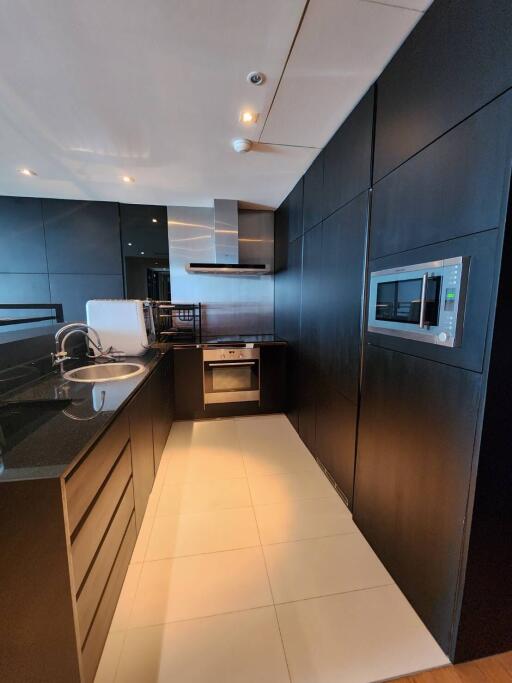 Modern kitchen with black cabinetry and integrated appliances