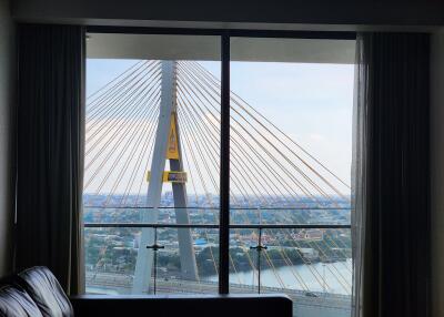 Living room with large window and bridge view