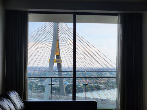 Living room with large window and bridge view