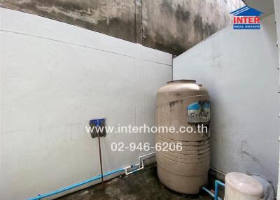 Outdoor utility area with water tank