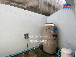 Outdoor utility area with water tank