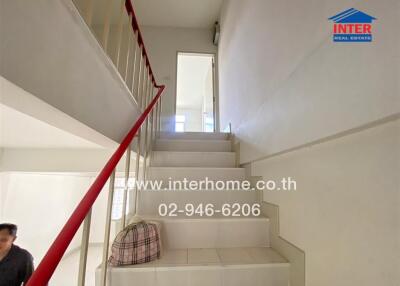 Staircase with a red railing