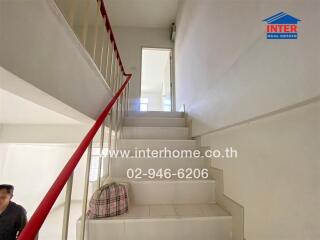 Staircase with a red railing