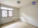 Empty bedroom with tiled flooring and metal-grilled windows