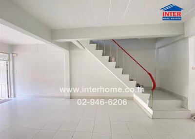 Living room with staircase and tiled flooring