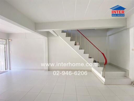 Living room with staircase and tiled flooring