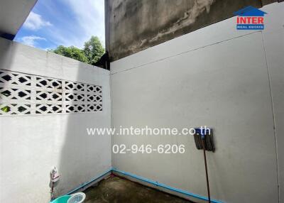 Outdoor utility area with concrete walls and open sky