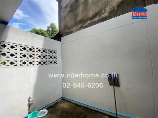 Outdoor utility area with concrete walls and open sky