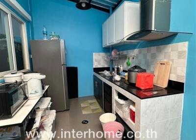 Modern kitchen with blue walls and various appliances