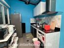 Modern kitchen with blue walls and various appliances