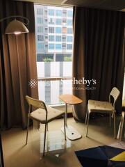 Living area with chairs and small table beside a window