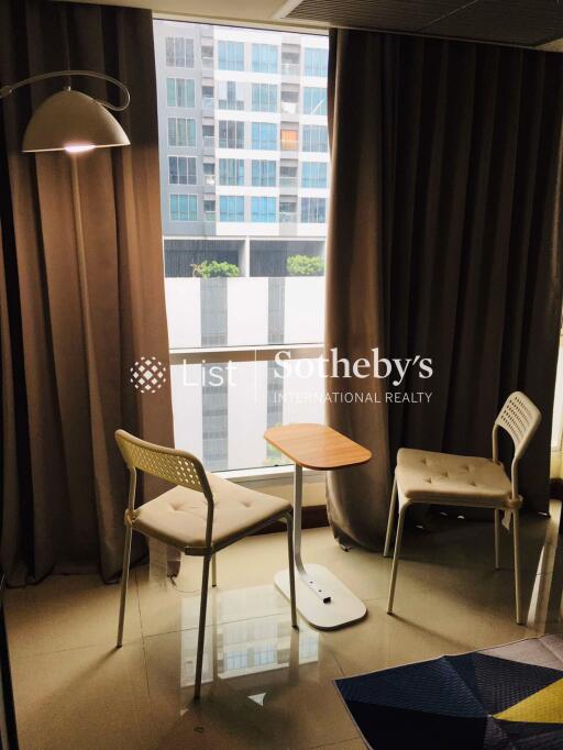 Living area with chairs and small table beside a window