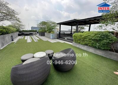 Rooftop garden with seating area and greenery