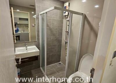 Bathroom with glass shower enclosure and sink