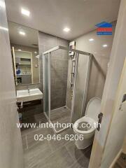 Bathroom with glass shower enclosure and sink