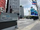 Main entrance of residential building with signage and associated real estate logos