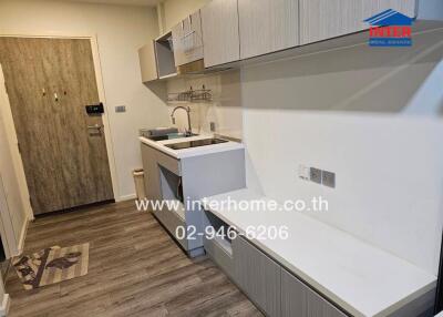 Modern kitchen with wooden flooring, sleek cabinets, and built-in appliances