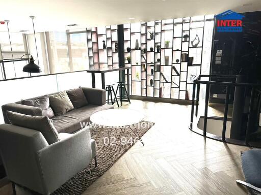 Modern living room with cozy seating and decorative shelving