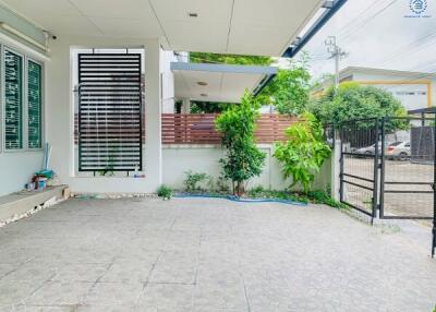 Paved outdoor area with plants and gate