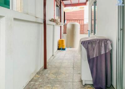 laundry area with washing machine and water tank