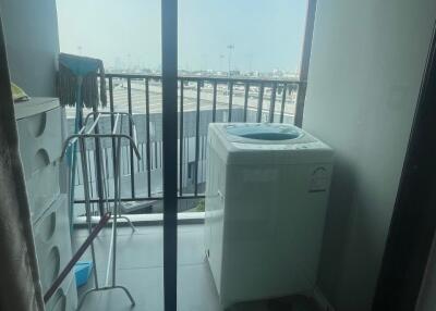 utility area with washing machine and balcony view