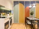 Modern kitchen and dining area with colorful wall panels